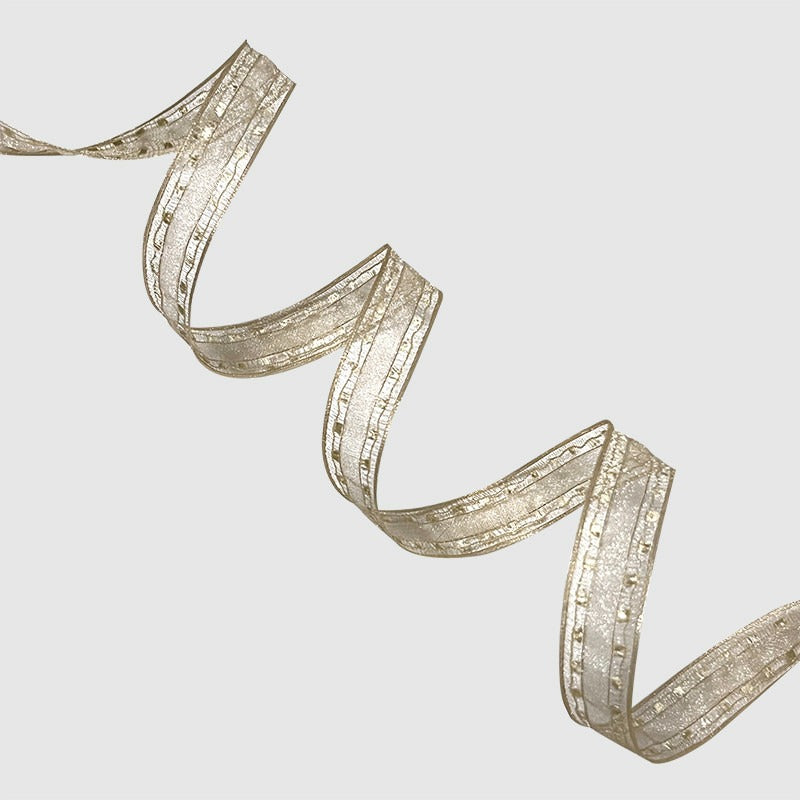 Caramel golden brown wired ribbon folded in zigzag showing warm sheen and wire-edged hold — Sivonna autumn ribbon
