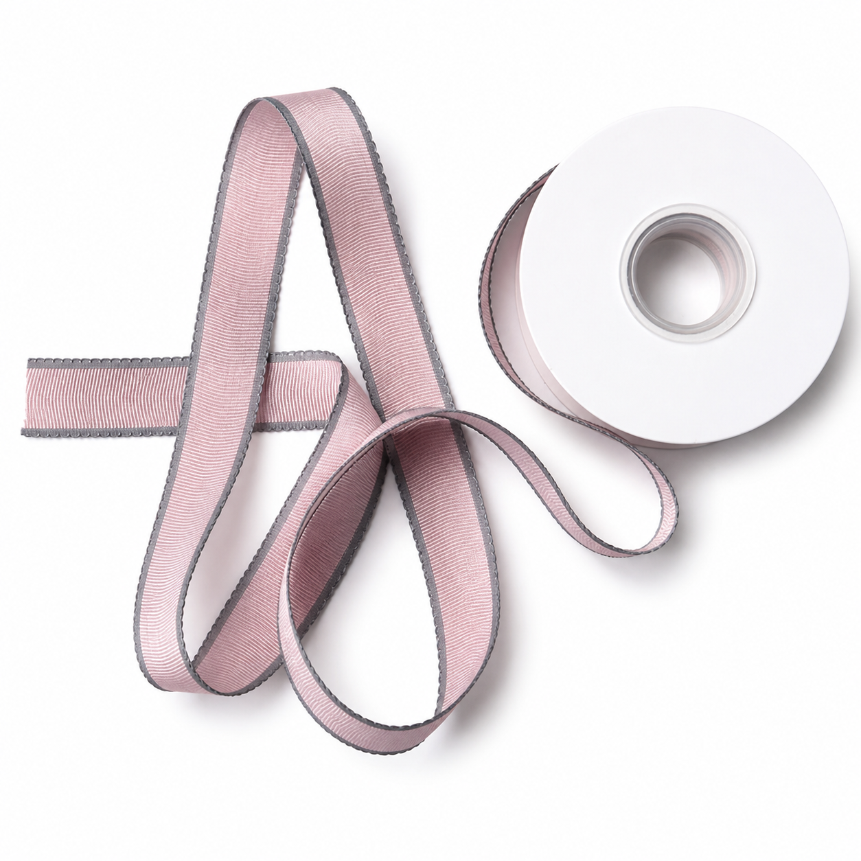 Dusty rose velvet and sheer ribbons draped in flowing curves beside white spool — Sivonna decorative ribbon set