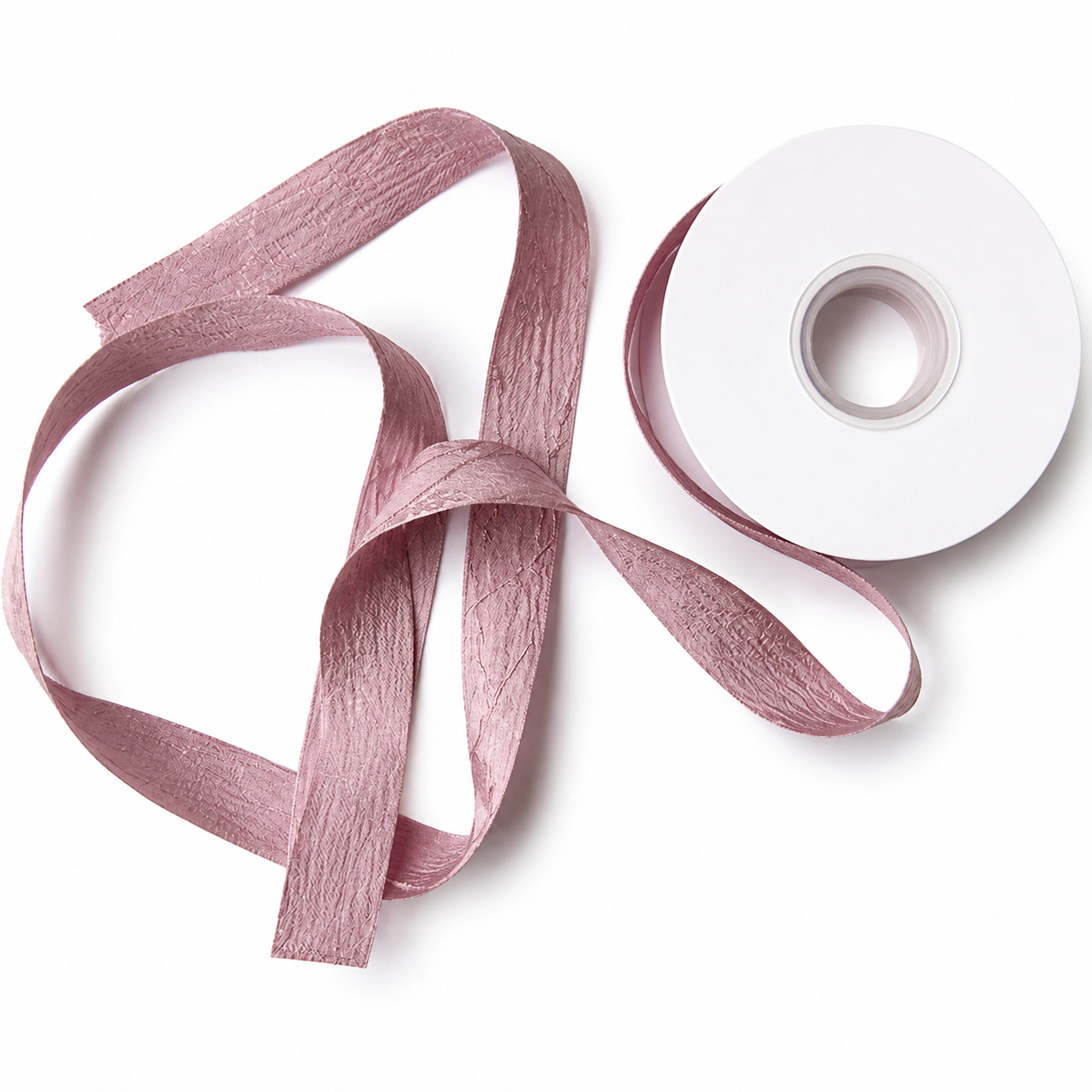 Blush pink satin ribbon curled into natural loops showing smooth surface and light sheen — Sivonna ribbon for bouquets and bows