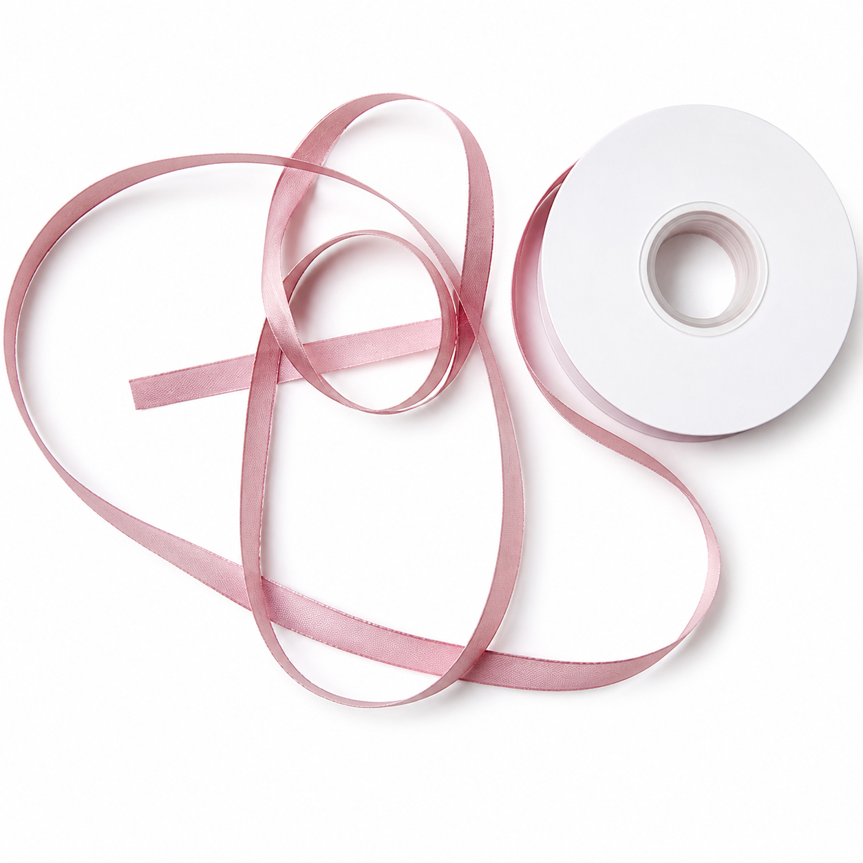 Pink sheer and satin ribbons crossed and layered over white spool showing tonal coordination across textures — Sivonna bridal bow making ribbon